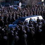 Police officers line the streets to pay respects to slain NYPD Officer Peter Figoski